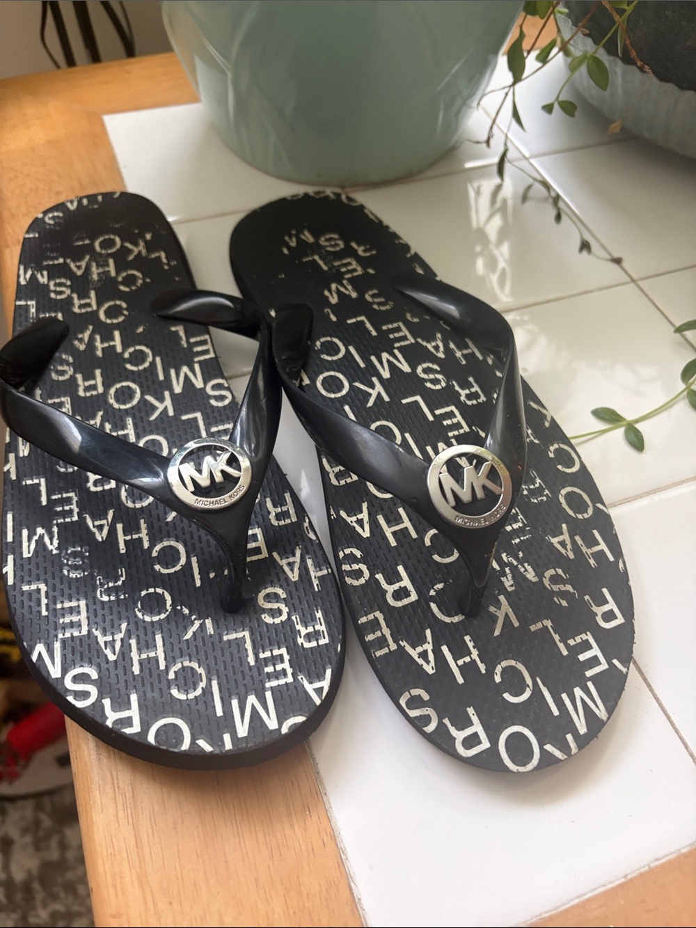 Michael Kors Black Logo Print Girls' Flip Flops with Silver MK Medallion